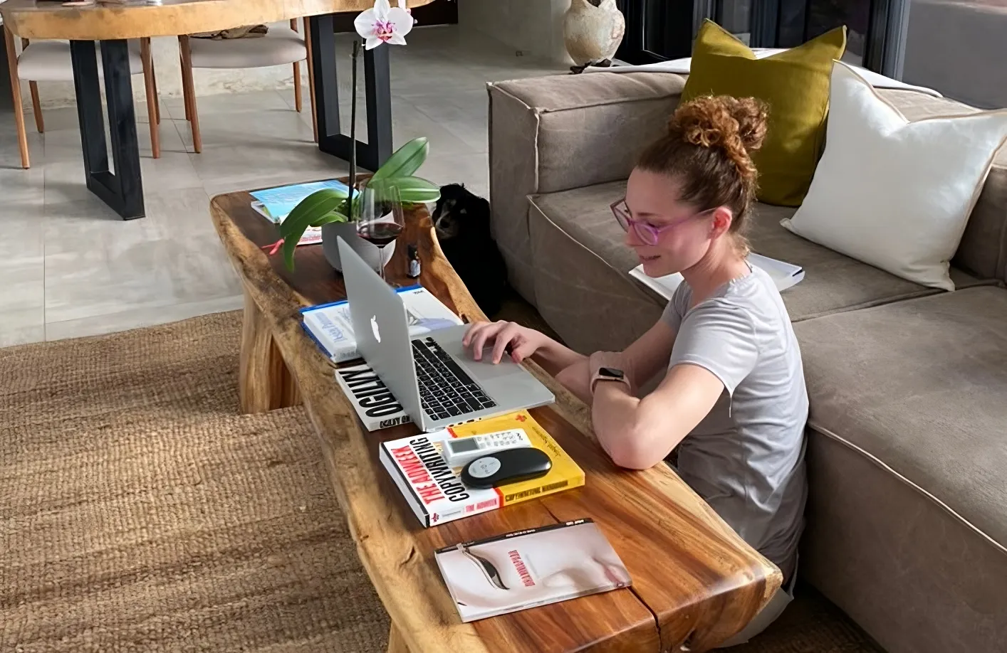 Krystal Ariel diligently working at her laptop in a cozy home environment, embodying the discipline and planning required to become unstoppable in achieving goals.